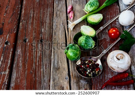 Green Bruxelles sprouts and mushrooms on a Wooden Background. Vegetarian food, health or cooking concept. Copyspace.