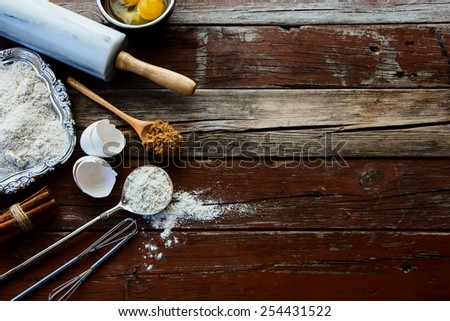 Baking background with raw eggs, sugar, cinnamon and flour. Top view.