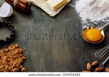 Baking  ingredients - flour, sugar, egg, butter on vintage wood table. Top view. Rustic background with free text space.