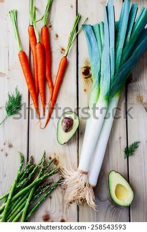 Top view of fresh vegetables on wooden background. Vegetarian food, health or cooking concept.