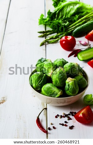 Brussel sprouts and Healthy Organic Vegetables on White Wooden Background.  Healthy food, diet or cooking concept.