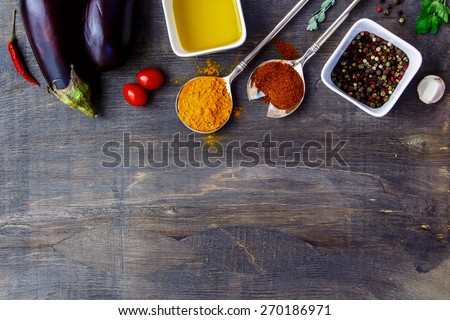 Aromatic herbs, spices and fresh vegetables on dark Wooden Background. Vegetarian food, health or cooking concept.