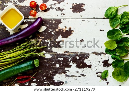 Ingredients, spices and herbs over rustic wooden background. Vegetarian food, health or cooking concept. Top view.