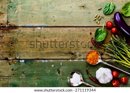 Food background with ingredients and spices on rustic wooden texture. Vegetarian food, health or cooking concept. Top view.