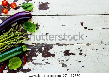 Aromatic herbs and vegetables on a old Wooden Background. Vegetarian food, health or cooking concept. Top view.