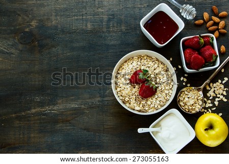 Healthy Breakfast. Yogurt with muesli and berries on rustic wooden background. Health and diet concept. Top view.