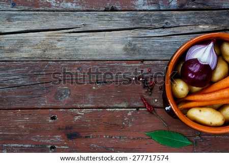 Fresh vegetables in rustic clay pot. Food background with space for text. Healthy food from garden. Top view.