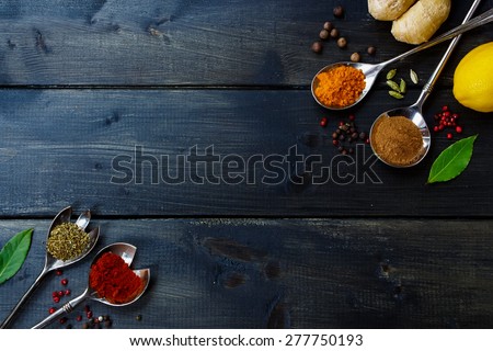 Healthy eating Background with herbs and spices selection on dark wooden table. Food or cooking concept, top view.