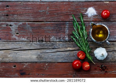 Herbs,spice, tomatoes and olive oil on rustic wooden table. Background with space for text. Cooking, vegetarian food or health concept