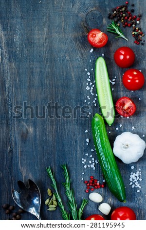 Cooking background with ingredients on dark wooden table with space for text. Vegetarian food, health or cooking concept.
