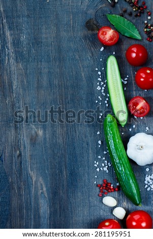 Food background with ingredients on dark wooden table with space for text. Vegetarian food, health or cooking concept.