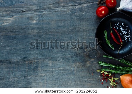 Food ingredients with vintage cast iron skillet on dark wooden background. Vegetarian food, health or cooking concept. Space for text.