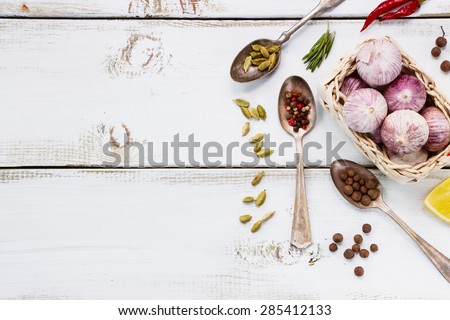 Close up of Spices. Herbs and spices selection - old metal spoons and white wooden background. Cooking, food or health concept.