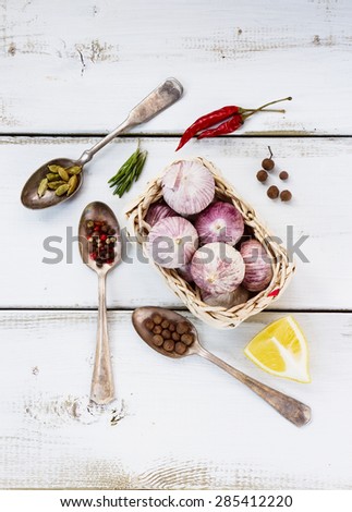 Spices over white. Herbs and spices selection - old metal spoons and white wooden background. Cooking, food or health concept.