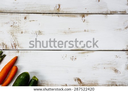 Food background. Organic ingredients for cooking on white wooden board with space for text. Vegetarian food, health or cooking concept.