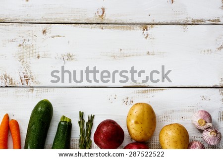 Organic ingredients for cooking on white wooden background with space for text. Vegetarian food, health or cooking concept.