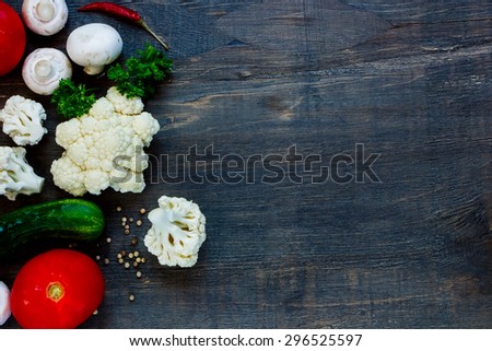 Farm fresh vegetables, herbs and mushrooms on rustic wooden background with space for text. Vegetarian food, health or cooking concept.