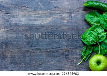 Green vegetables on dark wooden background with space for text - detox, diet or healthy food concept.