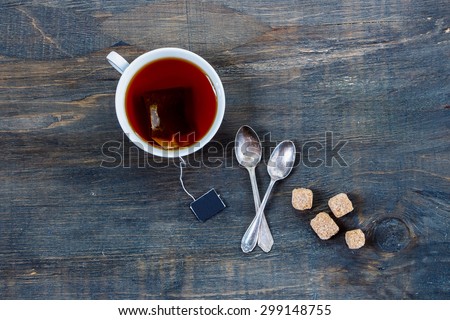 Top view of cup of tea on vintage wooden background.