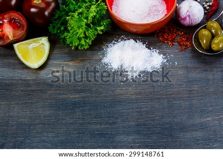 Food ingredients on dark wooden background with space for text. Vegetarian food, health or cooking concept.