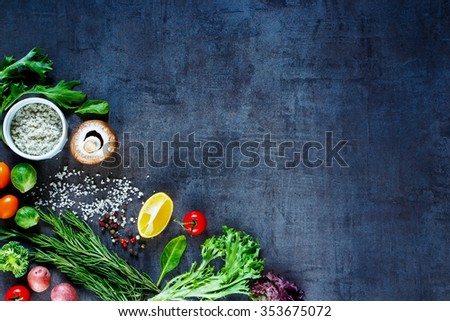 Colorful vegetables, fresh herbs and spices for healthy cooking on vintage table. Diet or vegetarian food concept. Background layout with free text space. Top view.