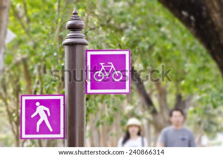 Bicycle and pedestrian lane road sign on pole post, bike cycling and walking walkway footpath route traffic roadside signal.