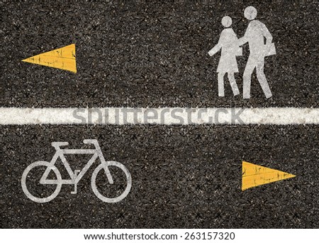 White line on the road divided walk sign and bicycle sign with yellow arrow.