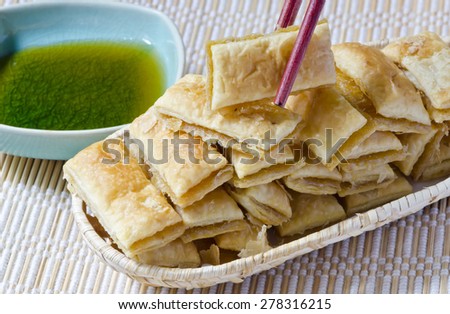 Mini Pineapple Pies serve with fresh honey on bamboo mat plate