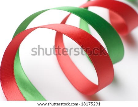 Red and green ribbon curling on white background