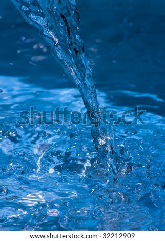 Stream of water pouring into a pool of water