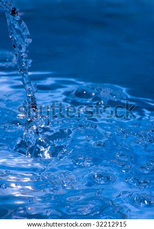 Stream of water pouring into a pool of water