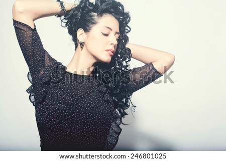 Model brunette with long curly hair. sensual brunette woman with shiny curly silky hair studio shot.