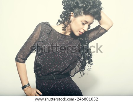 Model brunette with long curly hair. sensual brunette woman with shiny curly silky hair studio shot.