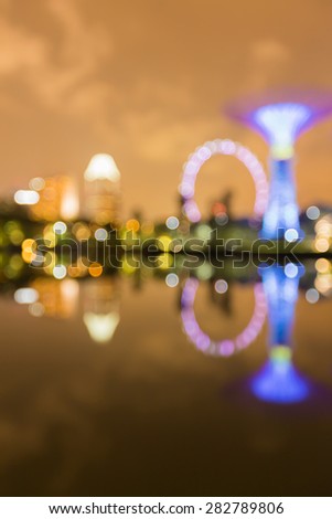Abstract blur of Gardens by the Bay bokeh lights with water reflection, Singapore