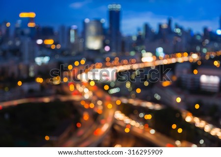 Blurred bokeh lights of city freeway intersection with cit