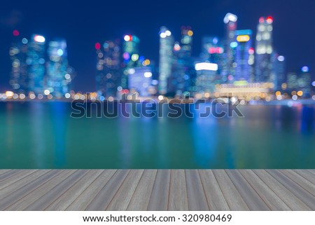 Opening wooden floor, Singapore city Skyline at Night- Blurred Photo bokeh