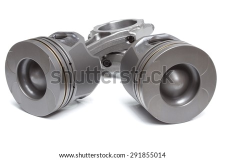 a set of pistons and rods for automobile engine on a white background