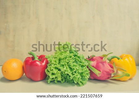 fresh vegetables and fruits on wooden wall vintage color tone