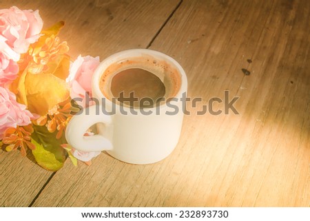 sweet morning with coffee on wooden table under soft light of sunrise