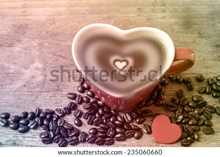 red heart cup of coffee on wooden table,love coffee concept.