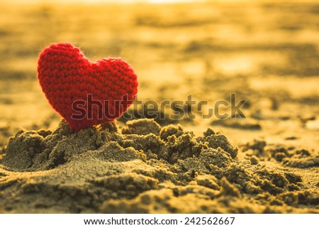 sweet heart on sand beach under sunset and warm light. abstract background love summer on the beach.