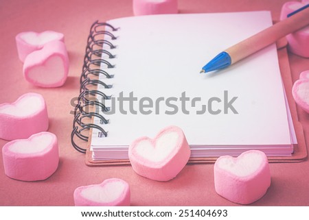 sweet heart shape of marshmallows with note book on wooden background,decoration for love and valentine day concept.