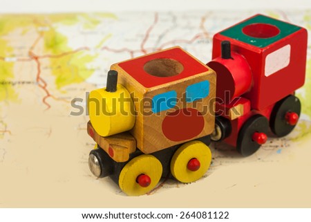 wooden toy train on map , abstract background for solution of transportation or traveling concept.