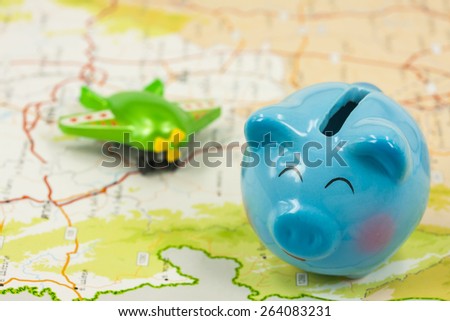 piggy bank and plastic airplane toy  over map ,abstract background to saving money for travel concept