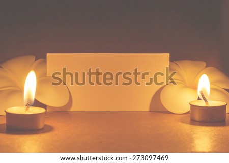 still life candle with flower and note paper,abstract background for pray or meditation caption.