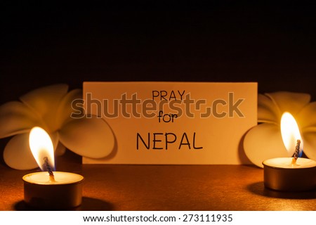 still life candle with flower and note pray for Nepal. background. candle flame at night.Abstract background background for pray for Nepal earthquake.