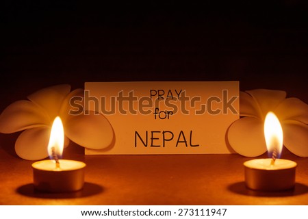 still life candle with flower and note pray for Nepal. background. candle flame at night.Abstract background background for pray for Nepal earthquake.