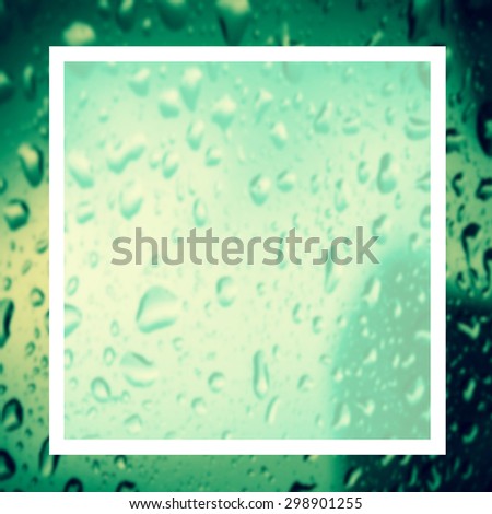 blank design frame label over blurred rain drop on window background,vintage color tone