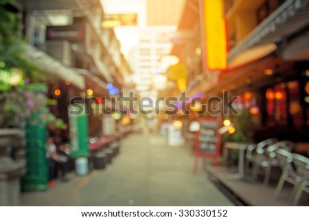 abstract blurred restaurant or coffee shop on shopping street background with lighting filter.