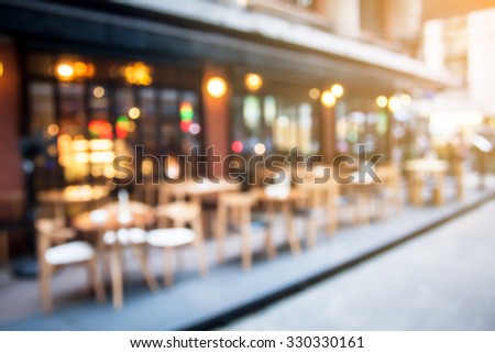 abstract blurred restaurant or coffee shop on shopping street background with lighting filter.